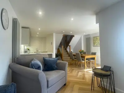 a living room with a couch and a table at Daisy Cottage in Keswick