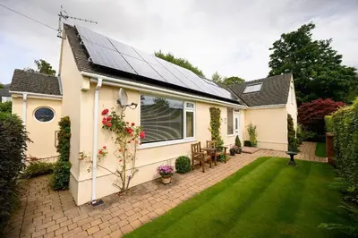 a house with a solar roof with a yard at Crosthwaite Gardens in Keswick