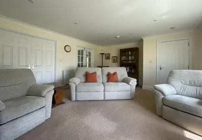a living room with two couches and two chairs at Crosthwaite Gardens in Keswick
