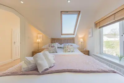 a bedroom with a large bed with towels on it at Crosthwaite Gardens in Keswick