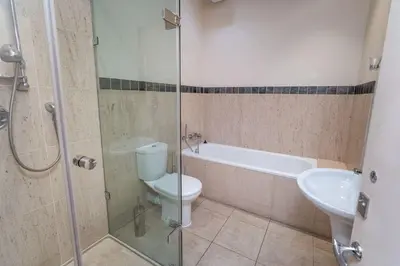a bathroom with a toilet and a shower and a sink at Crandy Nook in Keswick