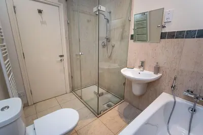 a bathroom with a shower and a toilet and a sink at Crandy Nook in Keswick