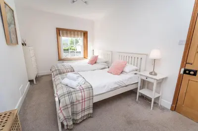 a small bedroom with a bed and a window at Coleridge Cottage in Keswick