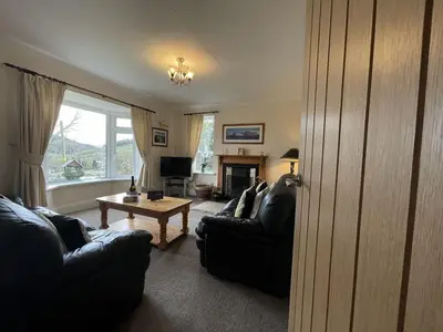 a living room with two black couches and a table at Rock Lynn in Braithwaite