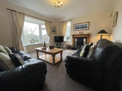 a living room with two black leather couches and a coffee table at Rock Lynn in Braithwaite
