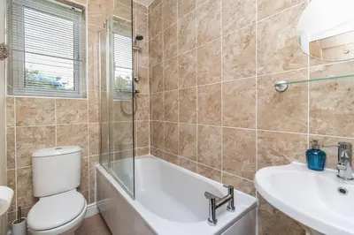 a bathroom with a tub and a toilet and a sink at Rose Bank Cottage in Braithwaite