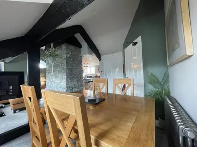 a dining room and living room with a table and chairs at Mountain View in Keswick