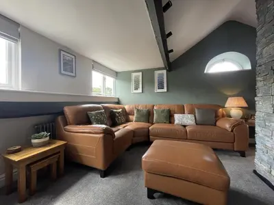 a living room with a couch and a table at Mountain View in Keswick