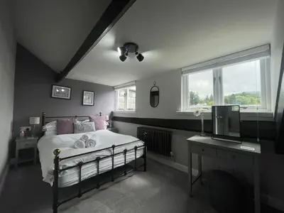 a bedroom with a bed and a desk and a television at Mountain View in Keswick