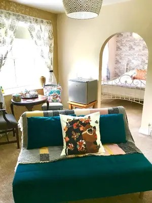 a blue couch with pillows in a living room at The Glen Mona Hotel in Maughold