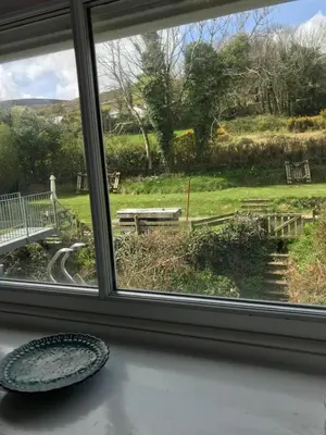 a window with a view of a park seen through it at The Glen Mona Hotel in Maughold
