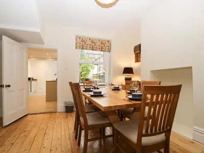 a dining room with a wooden table and chairs at Shields in Keswick