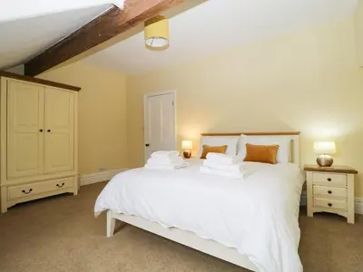 a bedroom with a large white bed with two lamps at Shields in Keswick