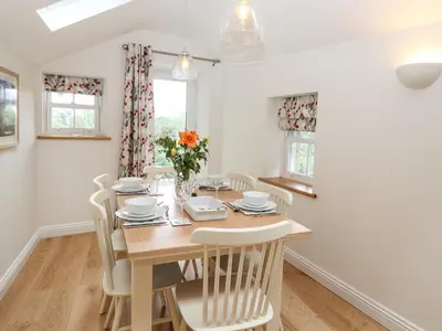 a dining room with a wooden table and chairs at Norton in Keswick