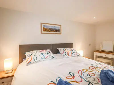 a bedroom with a large bed with two pillows at Norton in Keswick