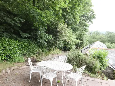 a white table and chairs in a garden at Norton in Keswick