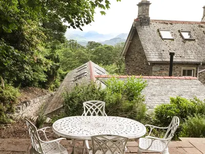 a table and chairs on a patio in front of a house at Norton in Keswick