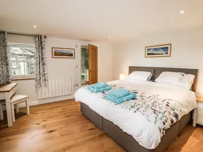 a bedroom with a bed and a desk and a window at Norton in Keswick
