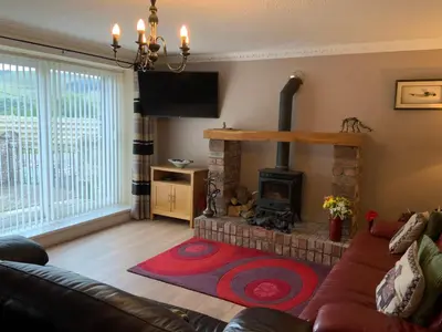 a living room with a couch and a fireplace at Parkside Mews in Frizington