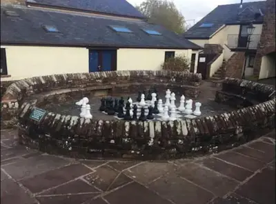 a chess game in a garden in front of a house at Ullswater Suite in Penrith