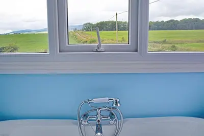 a window with a faucet in a room with at Beachcombers in Dumfries