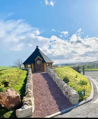a small building in the middle of a grassy field at A and C Lodge Plot 21 2 double bedrooms PLOT 21 With HOT TUB 1 pet only No Commercial Vans 4pm check in in High Hesket