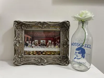 a picture in a frame next to a vase with a flower in it at Rose Apartment 2-Bed Apt Sleeps 4 Town Centre Ayr in Ayr