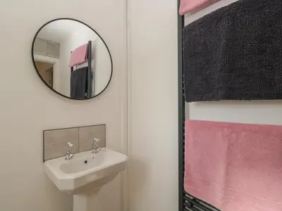 a bathroom with a sink and a mirror at 26 Hycemoor Way in Millom