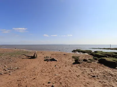 a sandy beach with the ocean in the background at Solway Firth View in Annan