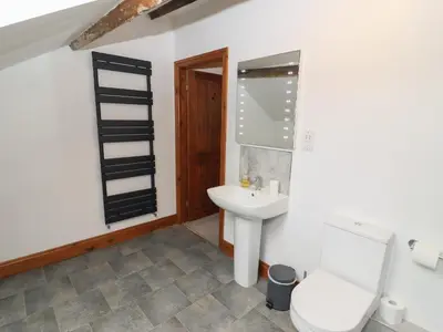 a bathroom with a toilet and a sink at Fryston Cottage in Keswick