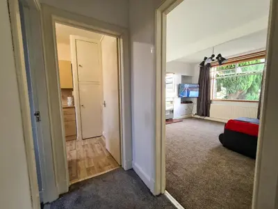 an empty room with a door leading to a bedroom at Lovely self-catering apartment in city centre in Dumfries