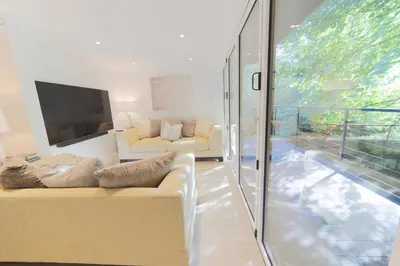 a living room with a couch and a tv at The Hide in Carlisle