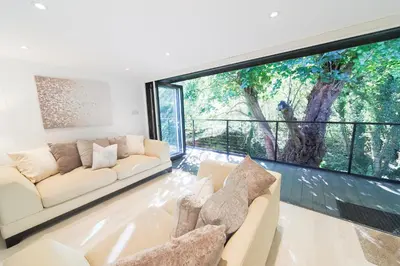 a living room with two couches and a large window at The Hide in Carlisle