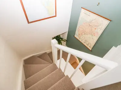 a staircase in a house with a map on the wall at Waterside in Ravenglass