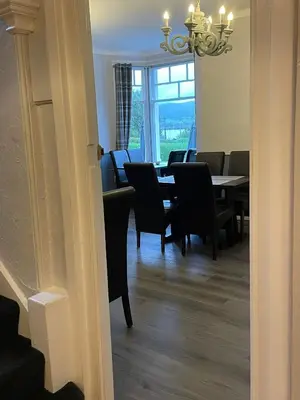 a dining room with a table and chairs and a window at Ouse Bridge House in Bassenthwaite Lake
