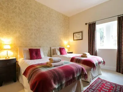 a bedroom with two beds with teddy bears on them at Cloud End in Keswick