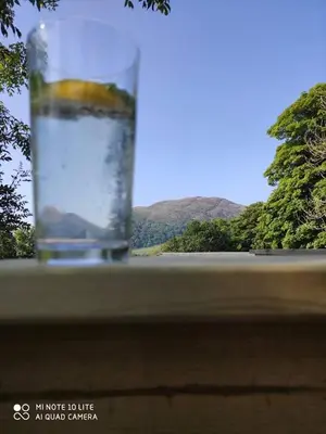 a glass of water sitting on top of a table at Unique Caravan with Outdoor Space Lodge in Ballantrae