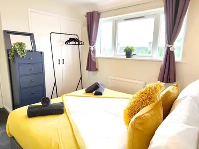 a bedroom with two beds and a window at Terrance House, modern, spacious in Carlisle