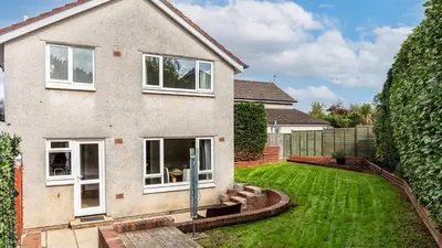 a house with a lawn in front of it at Leeward House - Donnini Apartments in Ayr
