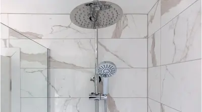 a shower with a shower head in a bathroom at Leeward House - Donnini Apartments in Ayr