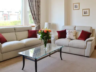 a living room with a couch and a glass coffee table at Stronvaar in Stranraer
