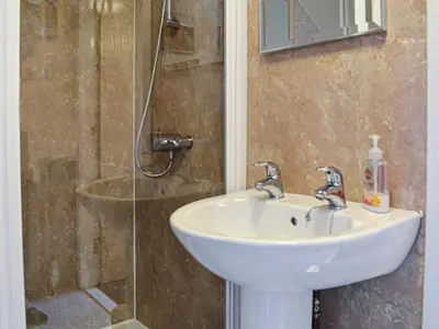 a bathroom with a sink and a shower at Kinvara in Stranraer