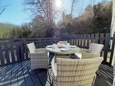 a table and four chairs on a deck with a table and chairs at Graylings Rest - Uk35759 in Brigham