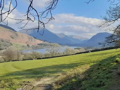 a green field with a lake and mountains in the background at Graylings Rest - Uk35759 in Brigham
