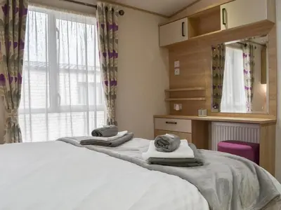 a bedroom with two beds with towels on them at Graylings Rest - Uk35759 in Brigham