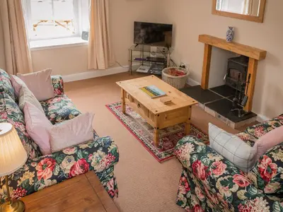 a living room with two couches and a coffee table at Uk35715 - South Cottage in Teviothead
