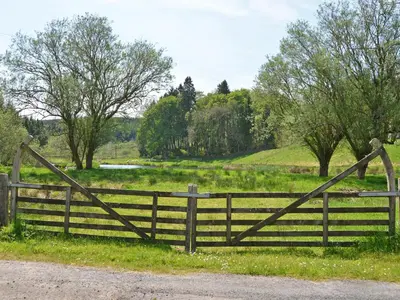 a wooden gate in a field with a fence at Uk35715 - South Cottage in Teviothead