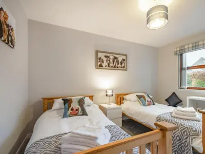 a bedroom with two beds and a window at Rowan Muir in Springside