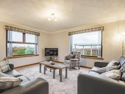 a living room with two couches and a tv at Rowan Muir in Springside
