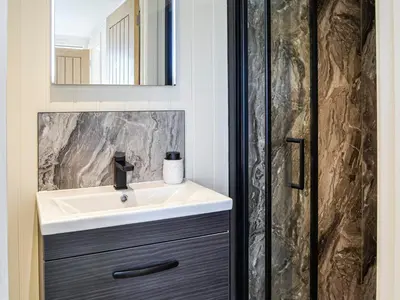 a bathroom with a sink and a mirror at The Seaview Snug in Whithorn